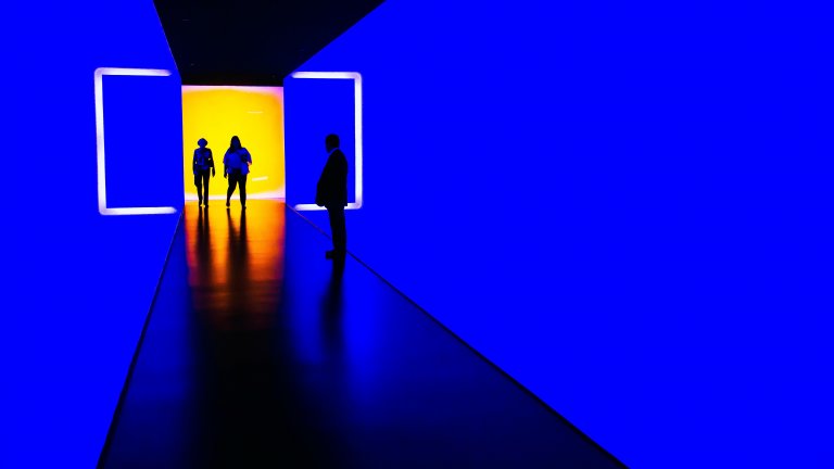 Three person standing near wall inside building