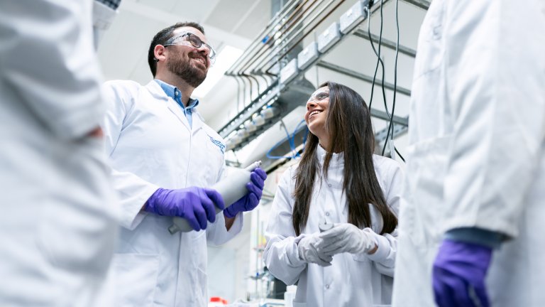 Chemical engineers talk in laboratory