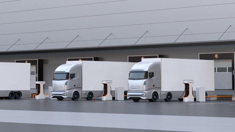 mehrere E-Lkw stehen im Depot und werden gerade geladen